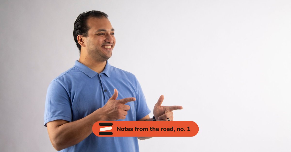 A smiling man making finger guns, with the tag Notes from the road, no. 1